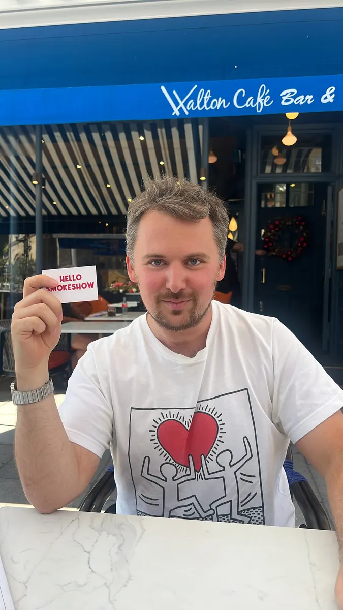 Someone holding up a Hello Smokeshow card
