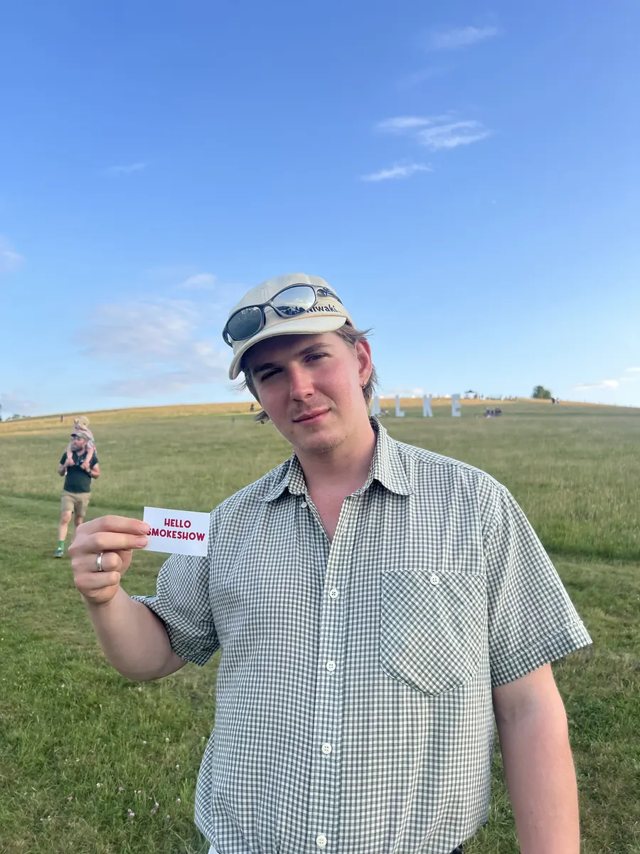 Someone holding up a Hello Smokeshow card