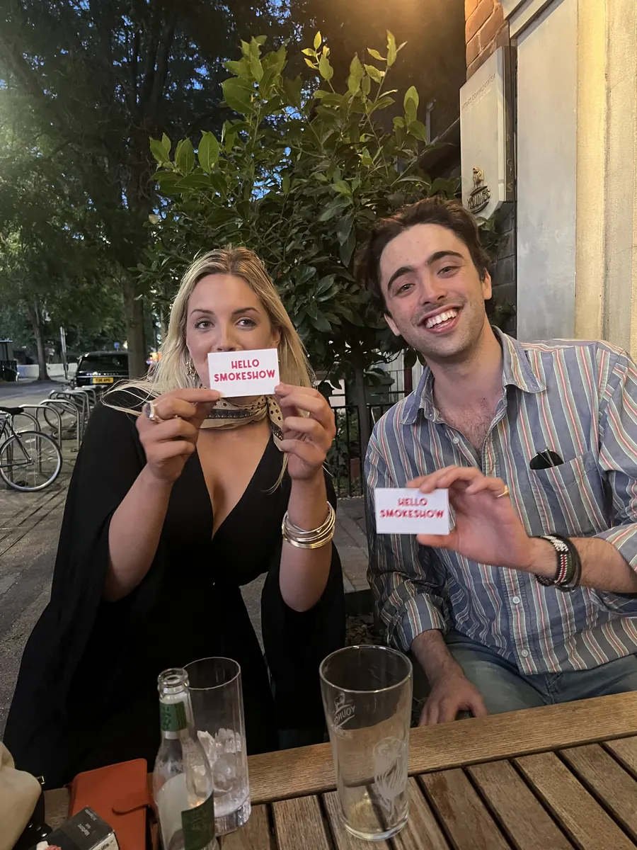 Someone holding up a Hello Smokeshow card