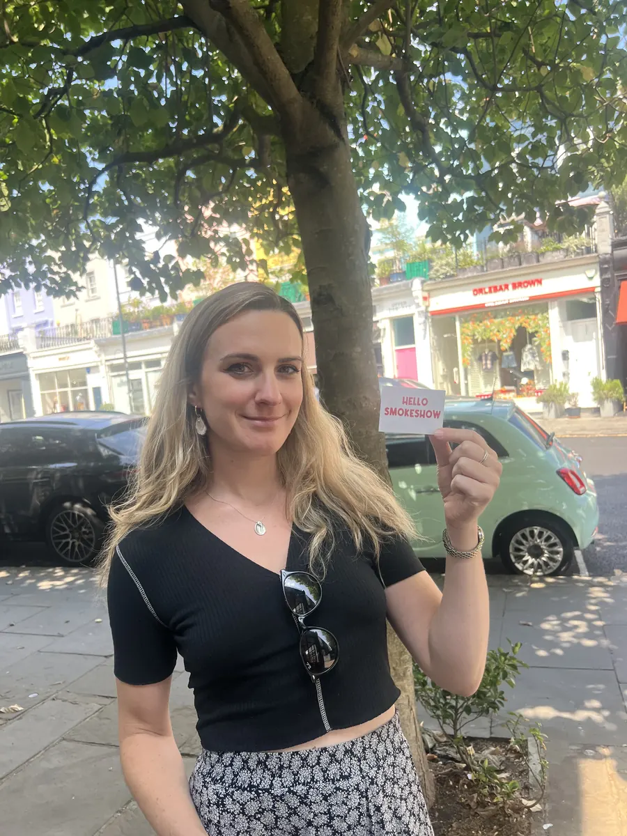 Someone holding up a Hello Smokeshow card