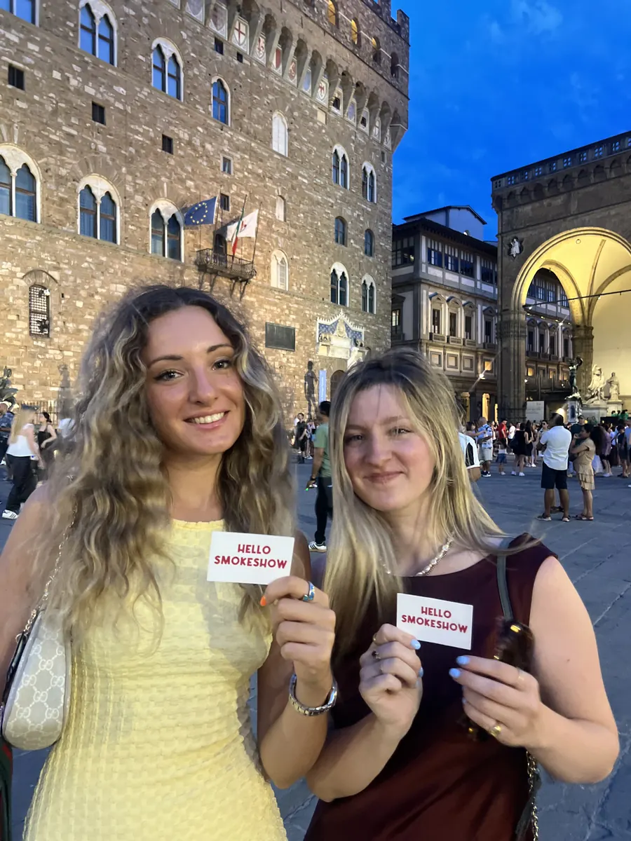 Someone holding up a Hello Smokeshow card