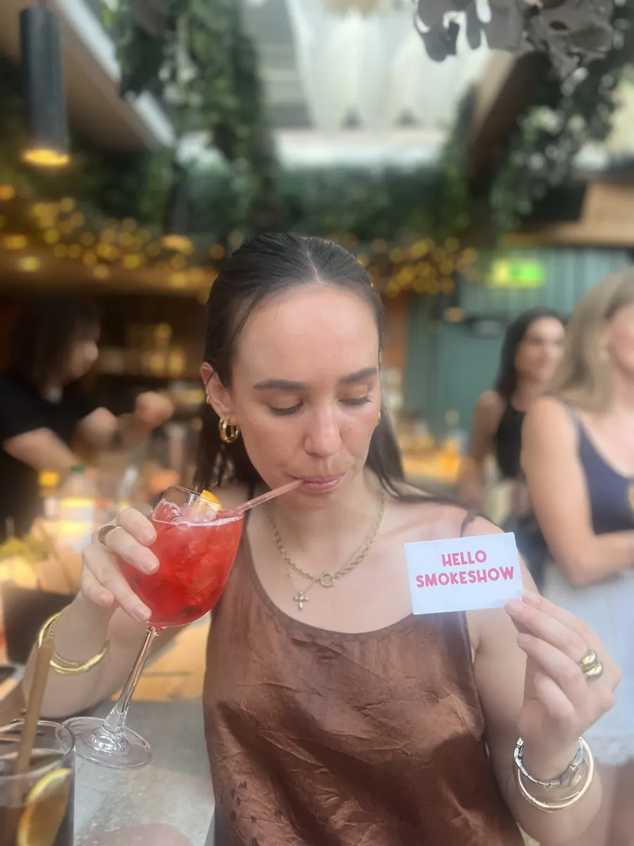 Someone holding up a Hello Smokeshow card