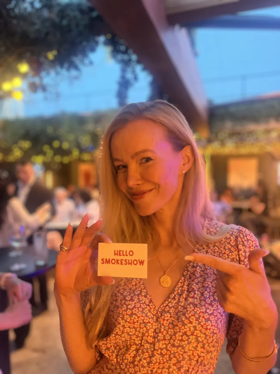 Someone holding up a Hello Smokeshow card