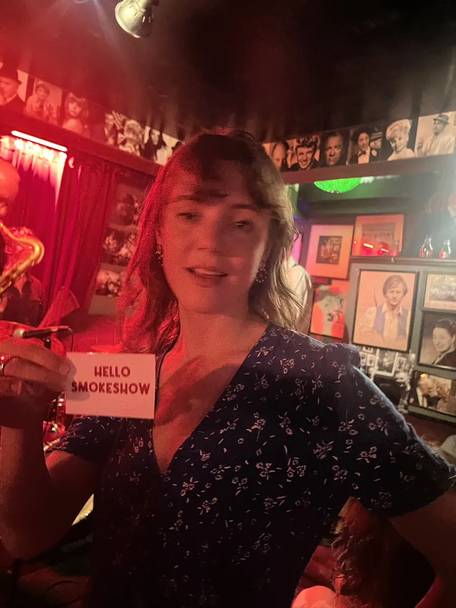 Someone holding up a Hello Smokeshow card