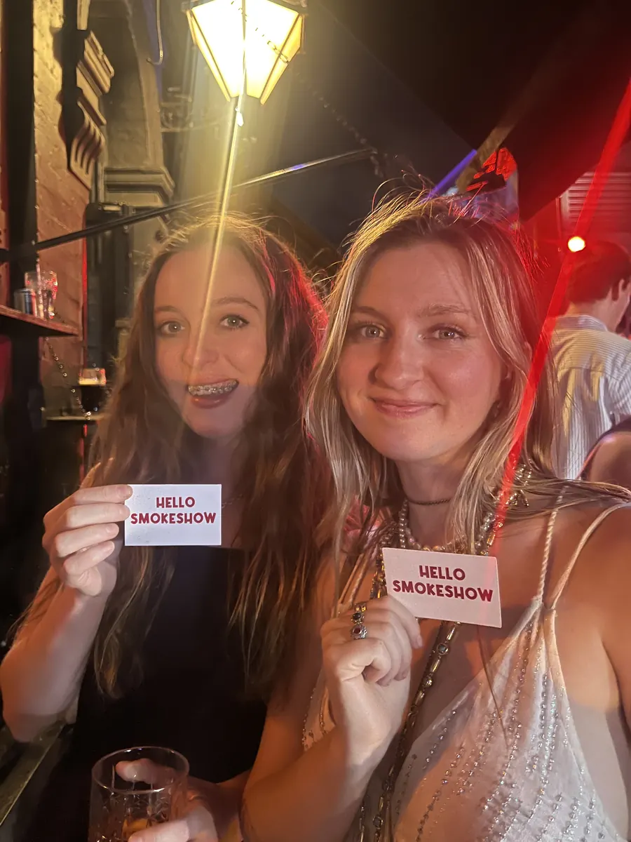 Someone holding up a Hello Smokeshow card